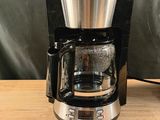 a coffee maker that is sitting on a wooden table