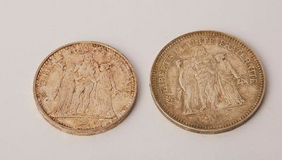 two british coins, one of which is a sovereign and one of which is a sovereign