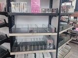 a lot of makeup products on the shelves in the store