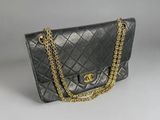 a chanel black quilted lambskin shoulder bag with gold chain