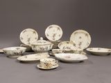 a lot of plates and bowls sitting on a table
