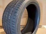 a close up of a tire on a cardboard surface with a cardboard box in the background
