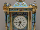 a blue and gold clock sitting on a table