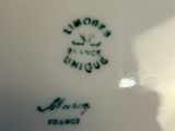 a white plate with a black and green design on it