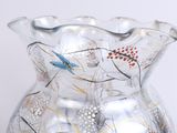 a glass vase with a design on it sitting on a table