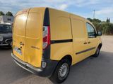 the back of a yellow van parked in a parking lot next to a black car