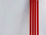 three red sticks sitting on top of a white table