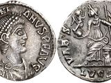a silver coin with an image of a woman and a man on it