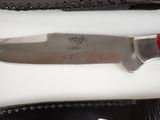 a knife that is sitting on a table next to a knife