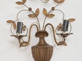 a wall mounted candle holder with two candles on it