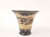 a vase that has a picture of a house on it