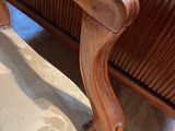 a close up of a chair with a cushion on it
