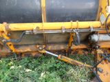 a yellow machine that is sitting in the grass