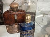 une étagère en verre sur laquelle sont posées de nombreuses bouteilles en verre