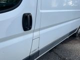 a white van that is parked on the side of the road