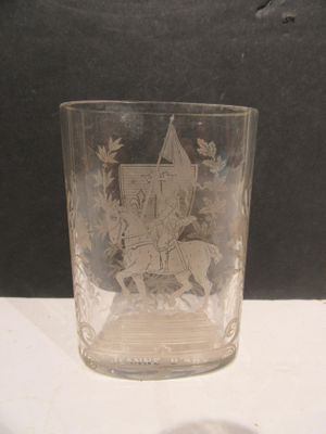 a glass with a picture of a knight riding a horse