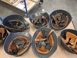 five bowls of baseball gloves and a baseball mitt on a table