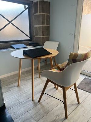 two chairs and a table in a small room