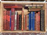 a wooden box filled with lots of books on top of a table