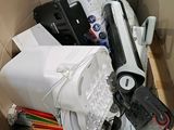 a cardboard box full of assorted electronics and other items