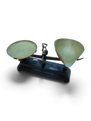 a scale with two bowls on it on a white surface