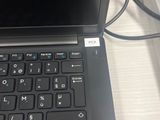 a laptop that is sitting on a desk with a keyboard