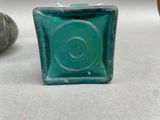 a small square glass object with a spiral design on it