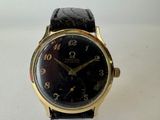 an image of a black and gold watch with roman numerals
