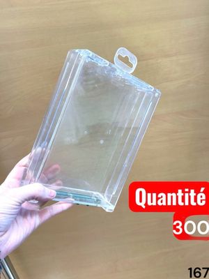 a person holding a clear plastic box with a handle