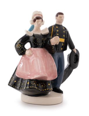 a figurine of a man and a woman dressed in military clothing
