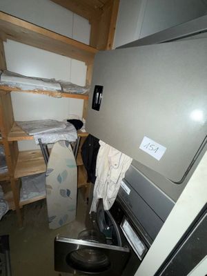 an image of a dirty laundry room with a washer and dryer