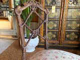 a chair that has a cushion on it in a room