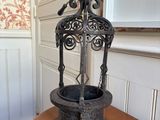a metal birdcage on a wooden table in a room