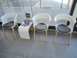 three chairs sitting next to each other in front of a window