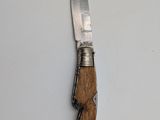 a small knife with a wooden handle on a white surface