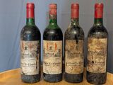 three bottles of wine sit on a wooden tray on top of a table