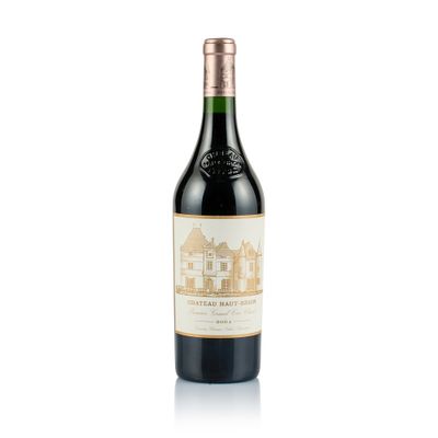 a close up of a bottle of wine on a white surface