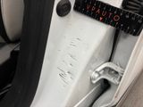 a close up of a car door with a measuring tape on it