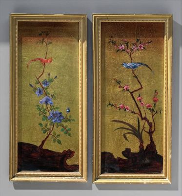 two framed paintings of flowers and birds on a wall