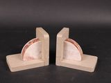 pair of marble bookends on wooden bases with a black background