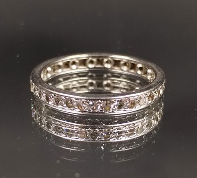 a close up of a diamond ring on a black surface
