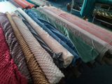 a lot of different colors of fabric on a rack