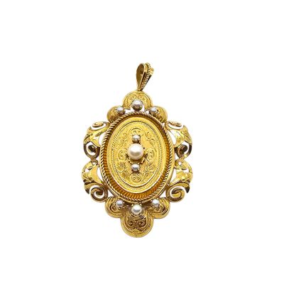 a close up of a gold pendant with pearls on a white background
