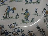 a plate with a picture of a knight and a bird on it