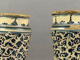 pair of blue and white vases with floral designs on them