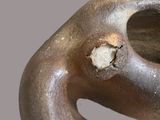 a metal sculpture with a hole in it