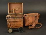 a small wooden box with a handle and a small suitcase with a handle