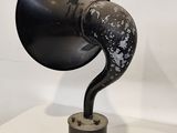 a black and white photo of an old gramphone on a table