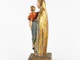 an old statue of a woman holding a child in her arms