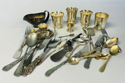 a lot of silver spoons and silverware on the table